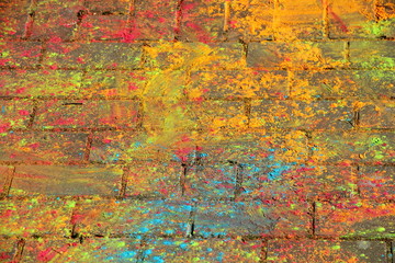 Multi-colored paints on the pavement on oaint Holi Festival - texture for background