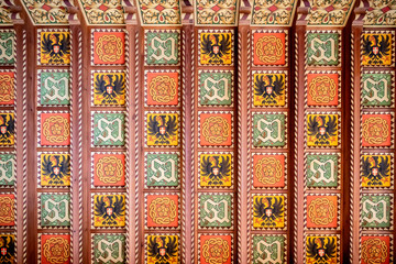 Savoia Castle inside. Wooden coffered ceiling decorated with the Savoyia crests. Aosta, Italy