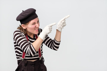 mime expressing dislike with gesture pointing with finger aside.