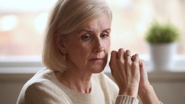 Sad thoughtful senior woman feeling lonely worried about problems