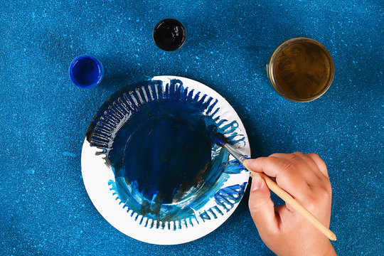 Diy Ramadan kareem crescent moon with a star from a disposable cardboard plate and gold paint. - Powered by Adobe