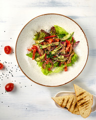 Top view of a beautiful plate with salad from meat and vegetables
