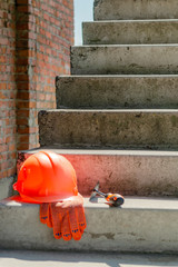 A pair of gloves and a Mason's helmet at the construction.