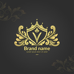Golden shield emblem. V letter. Elegant, classic vector. Can be used for jewelry, beauty and fashion industry. Great for logo, monogram, invitation, flyer, menu, background, or any desired idea.