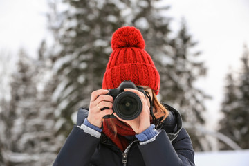 Female photographer at resort on winter day