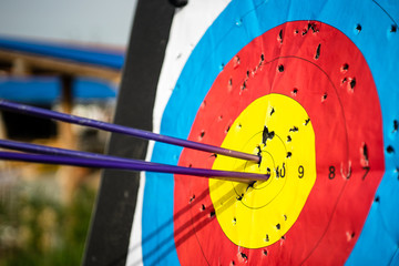 Close up on three arrows in the middle center of the target goal achieved success archery