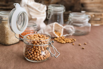 Glass jar with chickpea on kitchen table