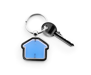 Key with trinket in shape of house on white background