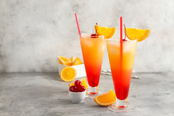 Glasses of Tequila Sunrise cocktail on table