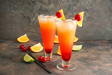 Glasses of Tequila Sunrise cocktail on table