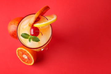 Glass of Tequila Sunrise cocktail on color background