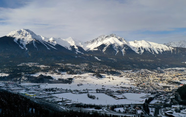 Panoramic view of idyllic winter wonderland mountain Alps on a sunny day with blue sky. Imst, Austria.