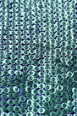 Fabric with sequins and sequins of bright colors. Fashion glitter fabric, sequins. Shiny surface