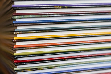 A stack of colorful books close up. A stack of multi-colored books close-up. View of the spine of the book.