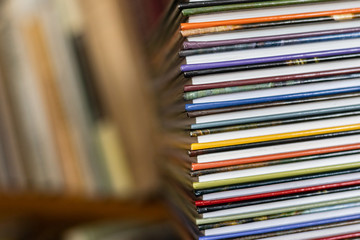 A stack of colorful books close up. A stack of multi-colored books close-up. View of the spine of the book.