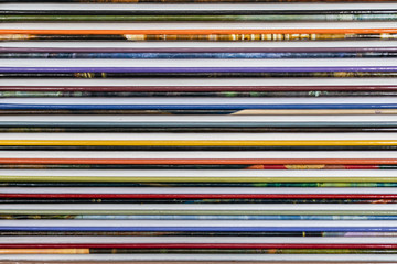 A stack of colorful books close up. A stack of multi-colored books close-up. View of the spine of...