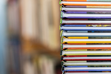 A stack of colorful books close up. A stack of multi-colored books close-up. View of the spine of...