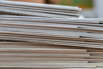 A stack of newspapers close-up. Lots of jagged paper sheets.