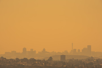 The Johannesburg skyline silhouetted against a golden sky