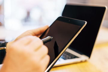 Sideview of male hand using devices