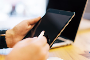 Sideview of businessman hand using devices