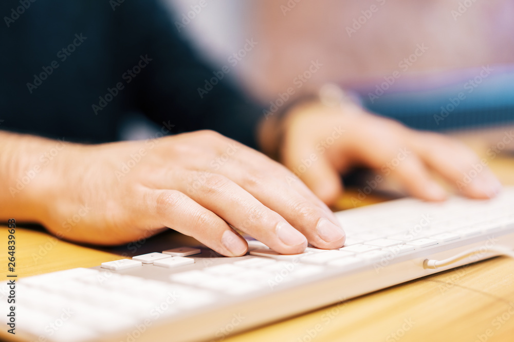Poster sideview of male hands using keyboard