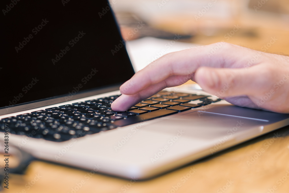 Poster man using clean laptop screen on desktop