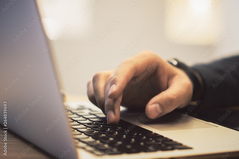 Poster sideview of man using notebook on desk top