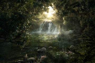 Fototapeta na wymiar Frau steht an paradiesischem Wasserfall im Dschungel