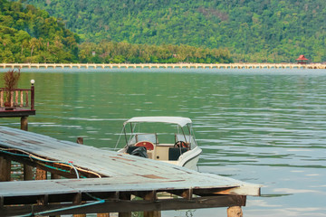 Beautiful landscape of Thailand, white boat on the water near the pier