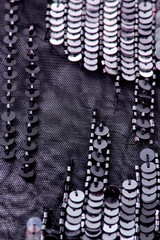 Fabric with sequins and sequins of bright colors. Fashion glitter fabric, sequins. Shiny surface