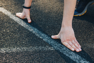 one runner on the starting line on the stadium track is waiting to start