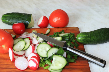 Tomatoes and cucumbers on a light wooden background, tasty and healthy food, diet food, harvesting in the village