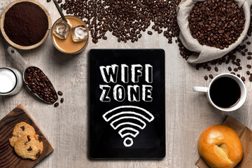 Coffee shop wifi zone sign signage with smart touch tab tablet and cafe espresso ingredients