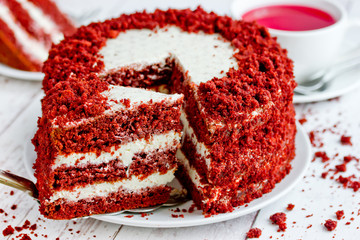 Red velvet cake, classic three layered cake from red butter sponge cakes with cream cheese...