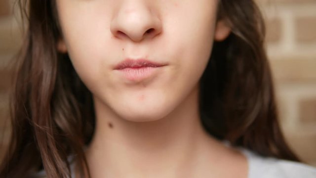close-up. child's mouth. teenager eats french fries.