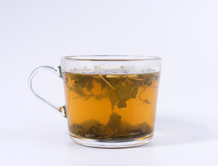 green herbal tea in a transparent cup isolated on white background