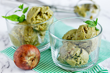 Green organic avocado ice cream, homemade healthy summer dessert dairy free ice cream from avocado, dates, mint, honey and matcha tea