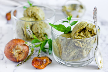 Green organic avocado ice cream, homemade healthy summer dessert dairy free ice cream from avocado, dates, mint, honey and matcha tea