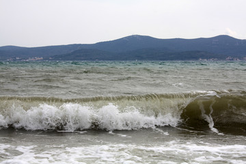 Adriatic Sea. Dalmatia. Landscape with waves and mountains on island.