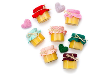 several jars of honey on a white background