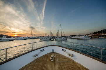 Wide angle shot of front of the yacht in marina in sunset