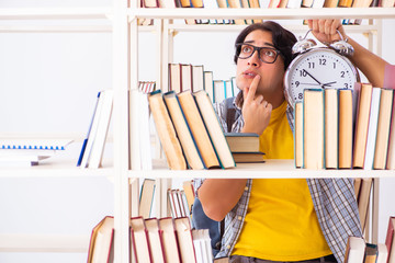 Male student preparing for exams at library 