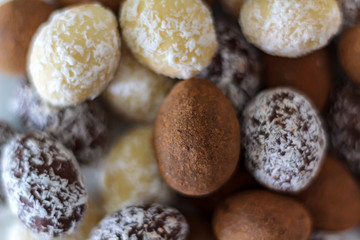 Fototapeta na wymiar White, dark and cocoa chocolate almond eggs