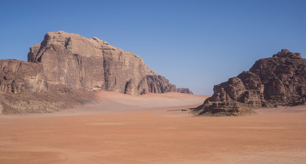 A beautiful day in the Jordanian desert of Wadi Rum. wide dessert with an amazing mountains and sand dunes , amazing scenery that you should see ! 