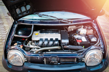 Small low budget used car engine compartment