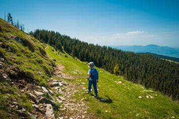 Fototapeta na wymiar Little boy hiking alone on mountain path
