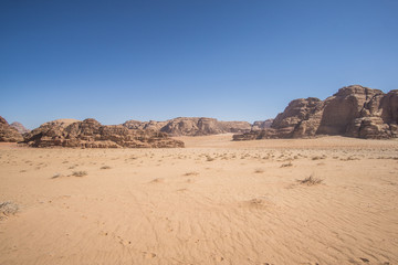 A beautiful day in the Jordanian desert of Wadi Rum. wide dessert with an amazing mountains and sand dunes , amazing scenery that you should see ! 