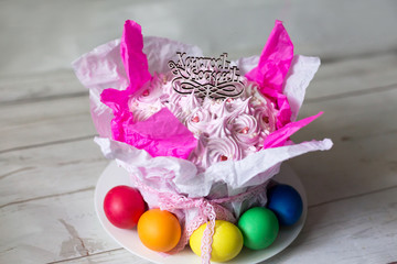 cake. the Easter cake and colored eggs. topper with inscription in Russian "Christ is risen"