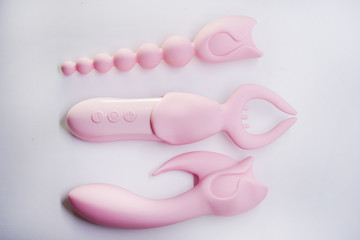 Bright sex toys on white background in the studio 